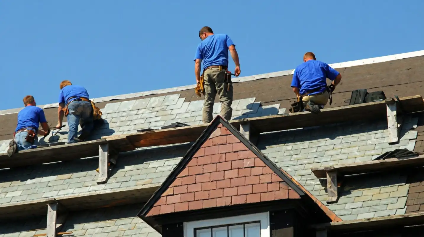 Roof replacement in progress with a team of professional contractors installing new shingles on a residential home in Naperville, IL