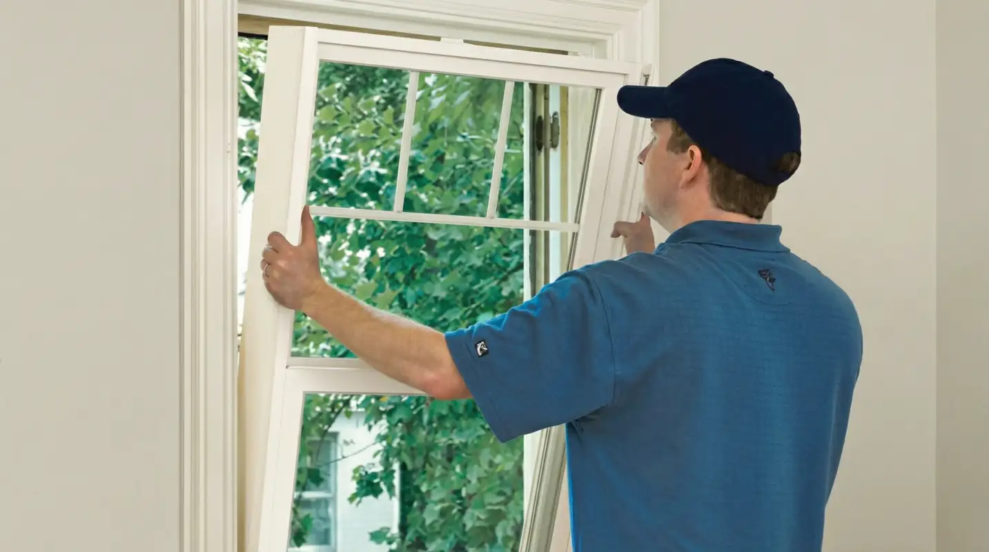 Professional contractors performing a residential window insulation and replacement service in Naperville, IL